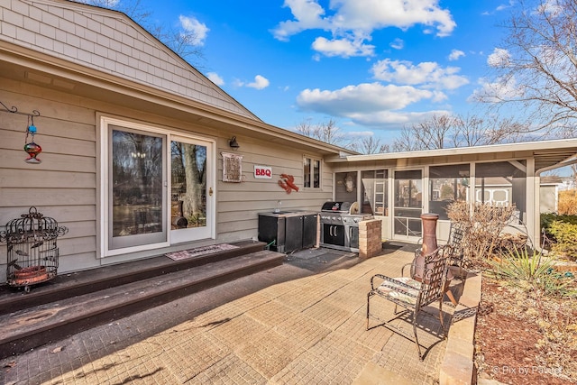 view of patio / terrace with a sunroom