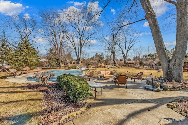 exterior space featuring a covered pool and a fire pit