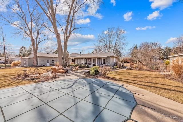 back of property with a lawn and a patio