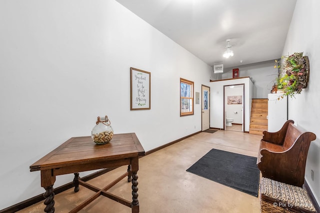 interior space featuring concrete flooring, visible vents, stairway, and baseboards