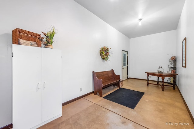 interior space with concrete flooring and baseboards