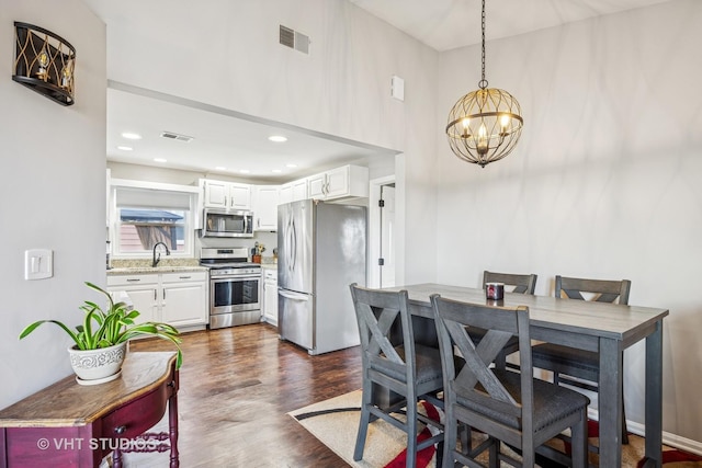 dining area with dark wood-style floors, visible vents, a notable chandelier, and recessed lighting