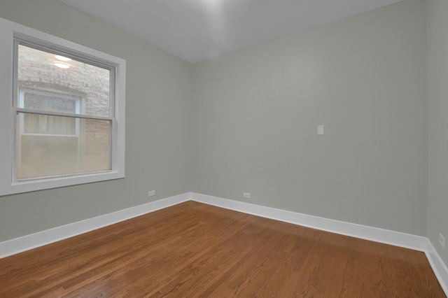 unfurnished room with wood finished floors and baseboards