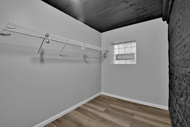 walk in closet featuring wood finished floors