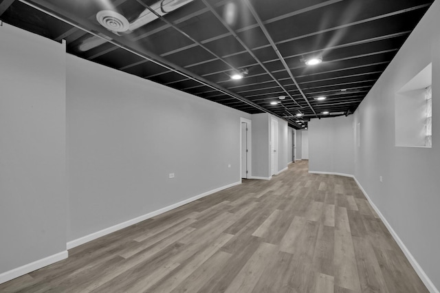 finished basement with baseboards and wood finished floors