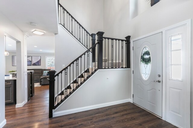 living room featuring a tiled fireplace, wood finished floors, a wealth of natural light, and crown molding