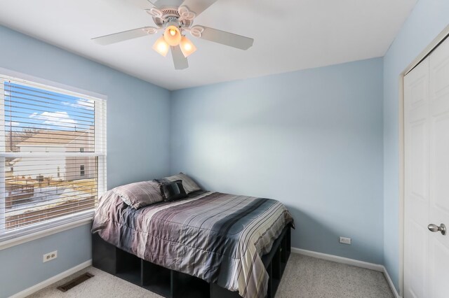 bedroom featuring lofted ceiling, baseboards, visible vents, and light colored carpet