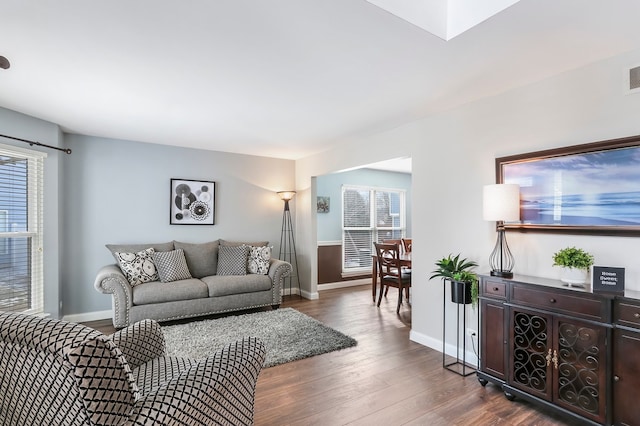 living room with visible vents, dark wood finished floors, and baseboards