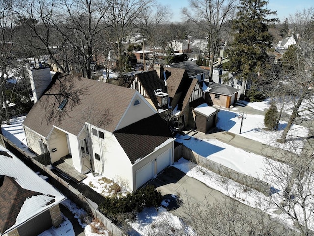 snowy aerial view with a residential view