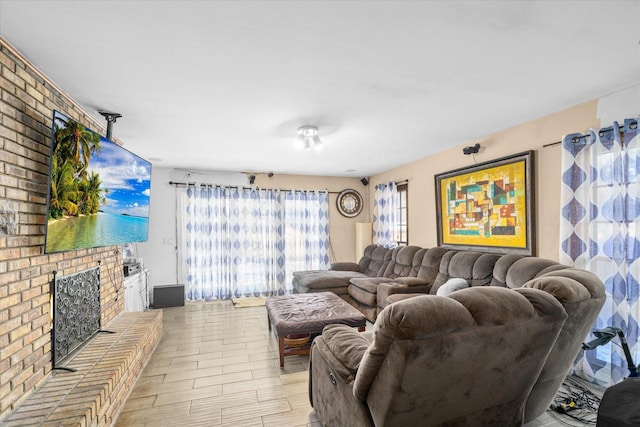 living room featuring a brick fireplace