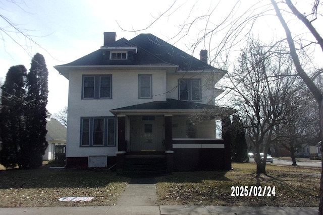 traditional style home featuring covered porch and a chimney