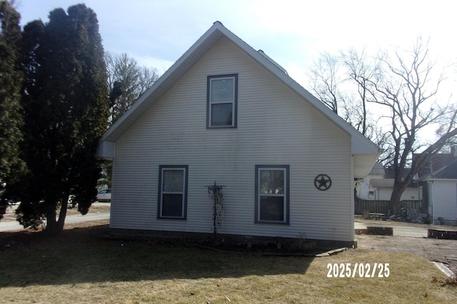 back of house with a lawn