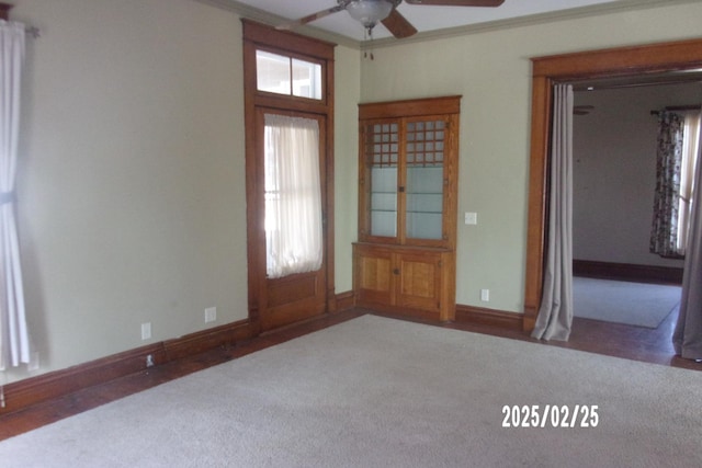 spare room featuring ornamental molding, carpet, and baseboards