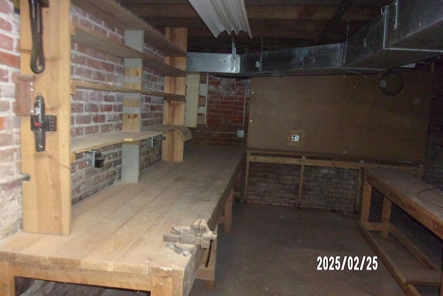 unfinished below grade area with a workshop area and dark wood-style flooring