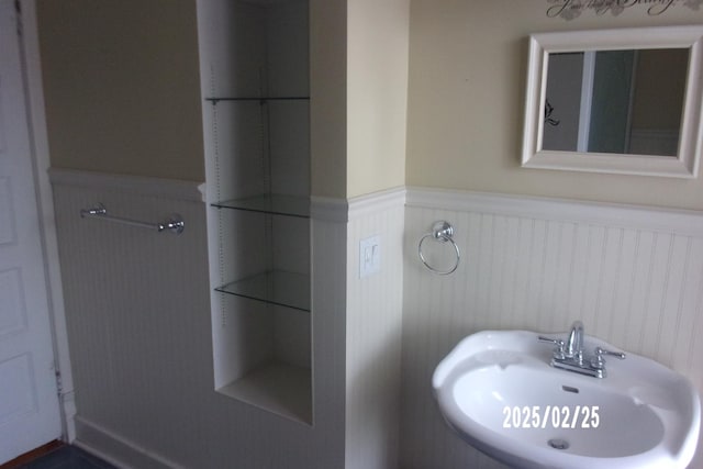 bathroom with wainscoting and a sink