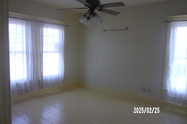 unfurnished room with a ceiling fan and a healthy amount of sunlight