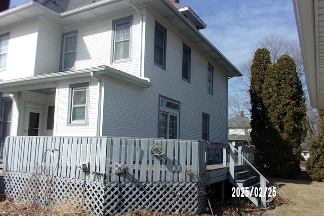 view of side of home with a deck