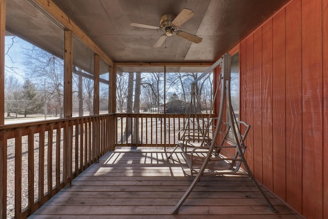 unfurnished sunroom featuring a ceiling fan