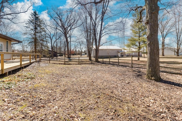 view of yard with a wooden deck and fence