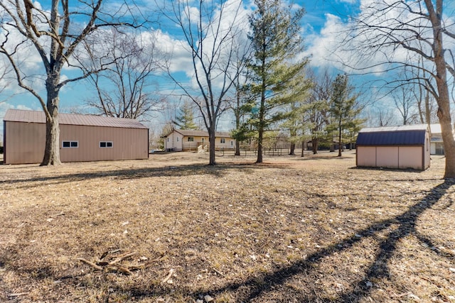 view of yard featuring a storage shed and an outbuilding