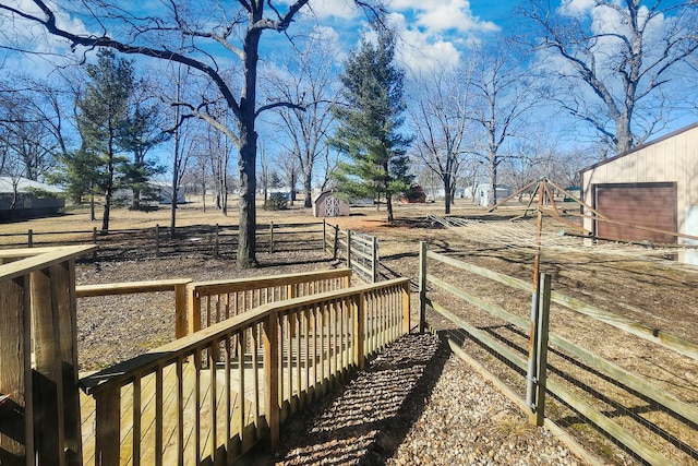 exterior space with a storage unit, an outdoor structure, and fence