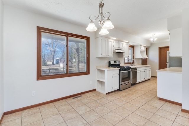 kitchen featuring under cabinet range hood, visible vents, stainless steel appliances, and light countertops