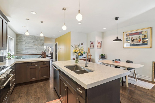 kitchen with dark brown cabinetry, appliances with stainless steel finishes, dark wood-style flooring, a sink, and recessed lighting