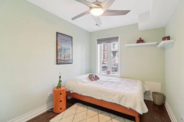 bedroom with ceiling fan, baseboards, and wood finished floors