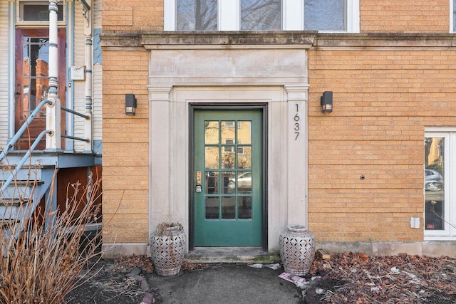 view of exterior entry with brick siding