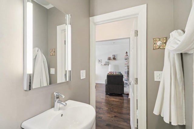 bathroom with a sink and wood finished floors