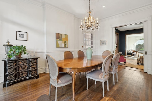 dining area featuring a healthy amount of sunlight, hardwood / wood-style flooring, and ornamental molding