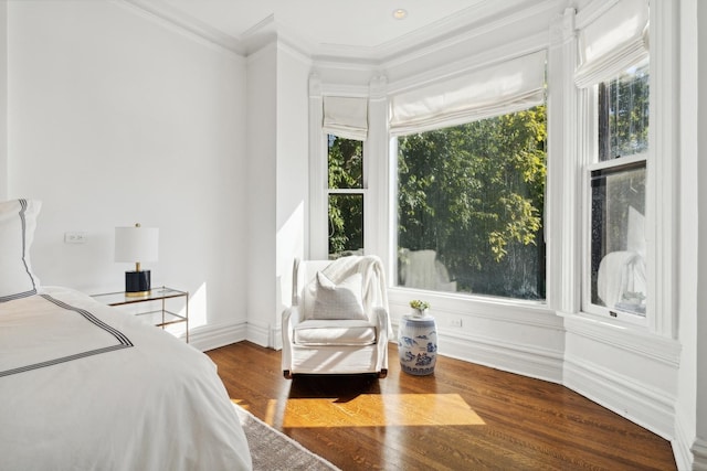 bedroom featuring wood finished floors, baseboards, and ornamental molding