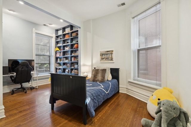 bedroom with wood finished floors and visible vents