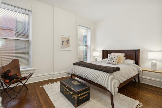 bedroom featuring baseboards and wood finished floors