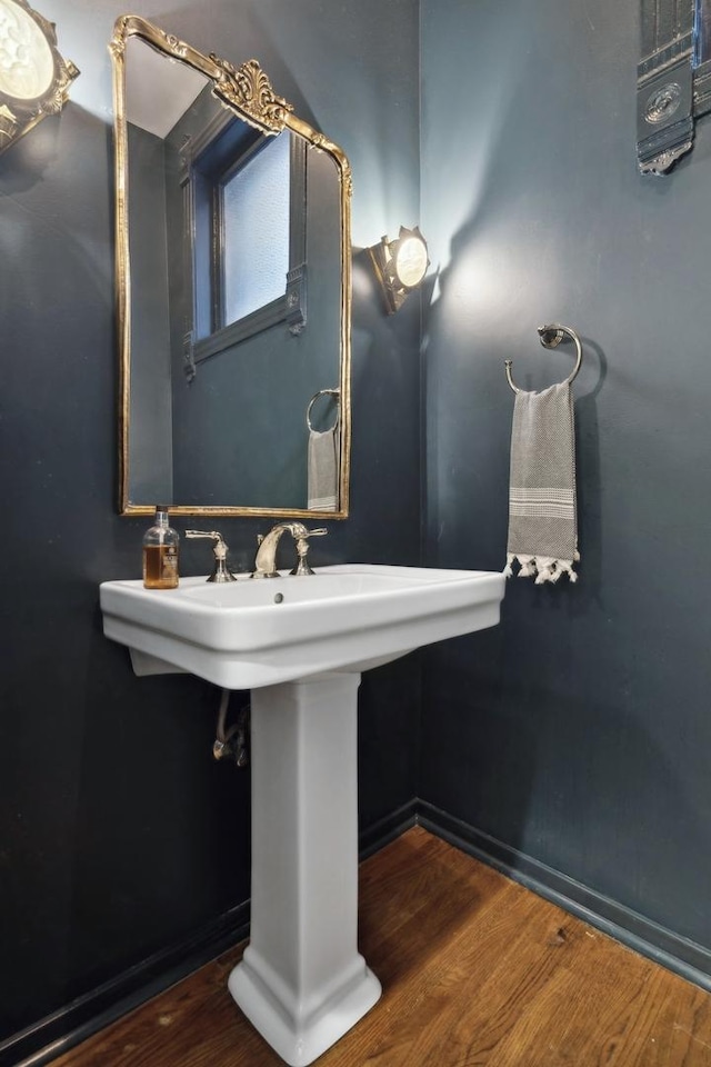 bathroom with baseboards and wood finished floors