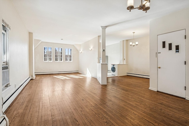 interior space featuring hardwood / wood-style floors, a baseboard heating unit, baseboard heating, and a chandelier