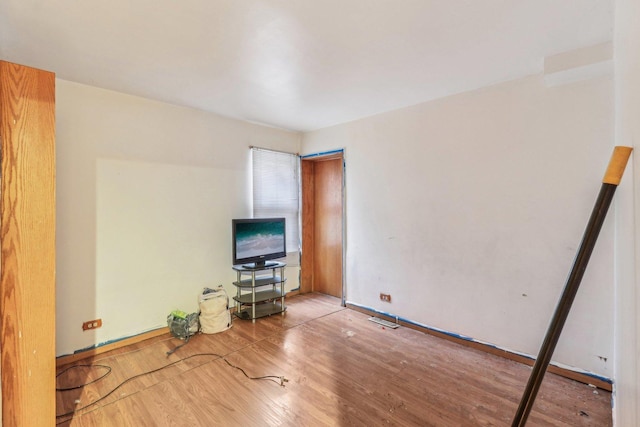 unfurnished living room with visible vents and wood finished floors