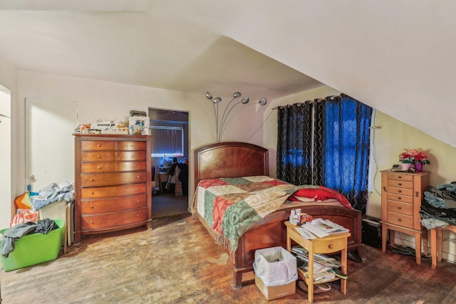 bedroom featuring lofted ceiling and wood finished floors