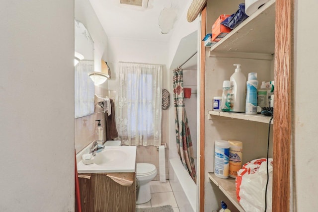 full bathroom featuring tile patterned flooring, toilet, tile walls, vanity, and shower / tub combo with curtain