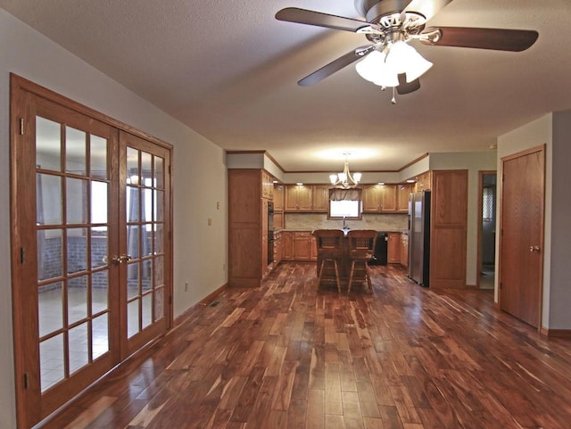 unfurnished dining area with a healthy amount of sunlight, french doors, dark wood-style flooring, and baseboards