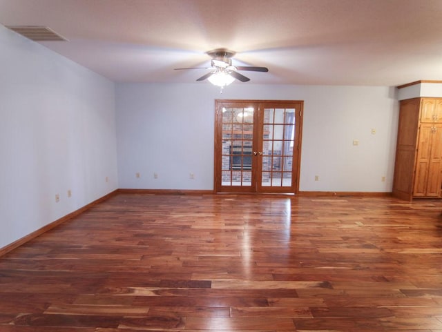 spare room featuring ceiling fan, dark wood-type flooring, visible vents, baseboards, and french doors