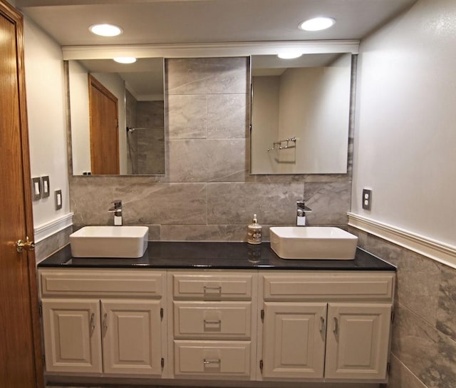 full bathroom featuring recessed lighting, a sink, and double vanity