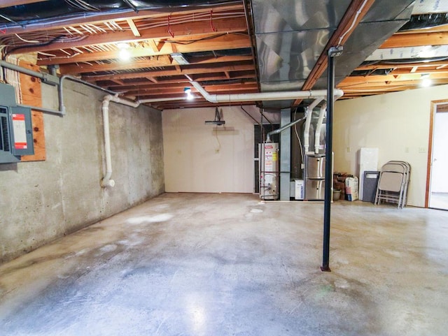 unfinished basement with heating unit, electric panel, and water heater