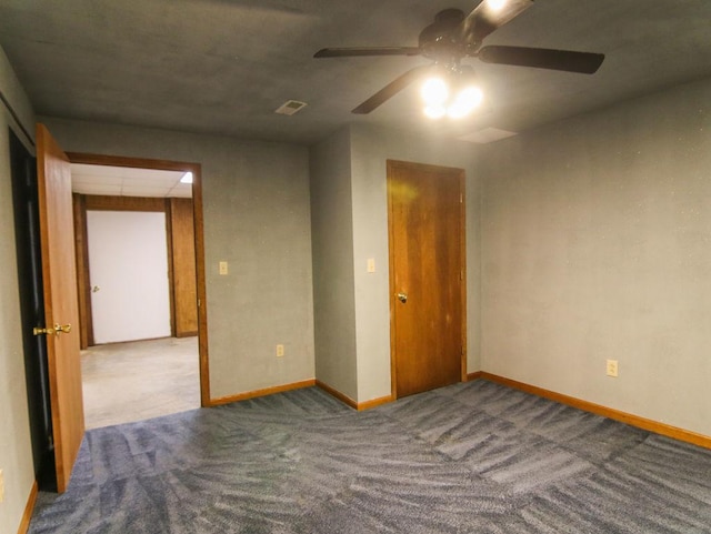 carpeted spare room with visible vents and baseboards