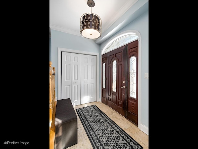 entryway featuring crown molding and baseboards