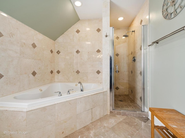 full bath featuring lofted ceiling, a stall shower, a bath, and tile walls