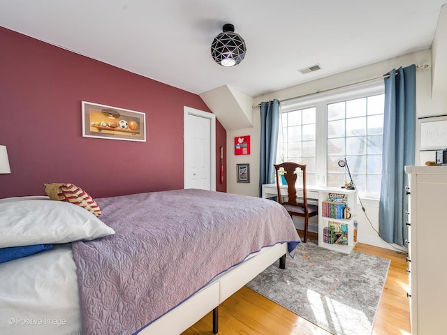 bedroom with light wood-type flooring and visible vents