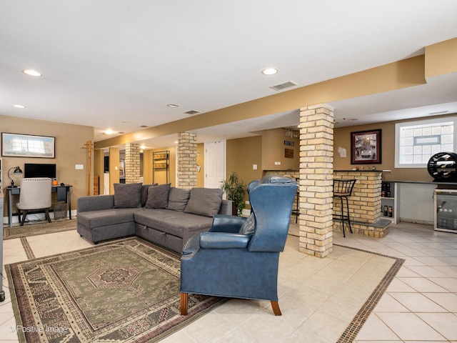 living room with visible vents, light tile patterned flooring, decorative columns, and recessed lighting