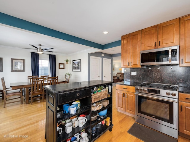 kitchen featuring stainless steel appliances, brown cabinetry, light wood-style flooring, and open shelves