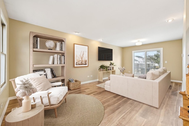 living room featuring light wood-style floors and baseboards